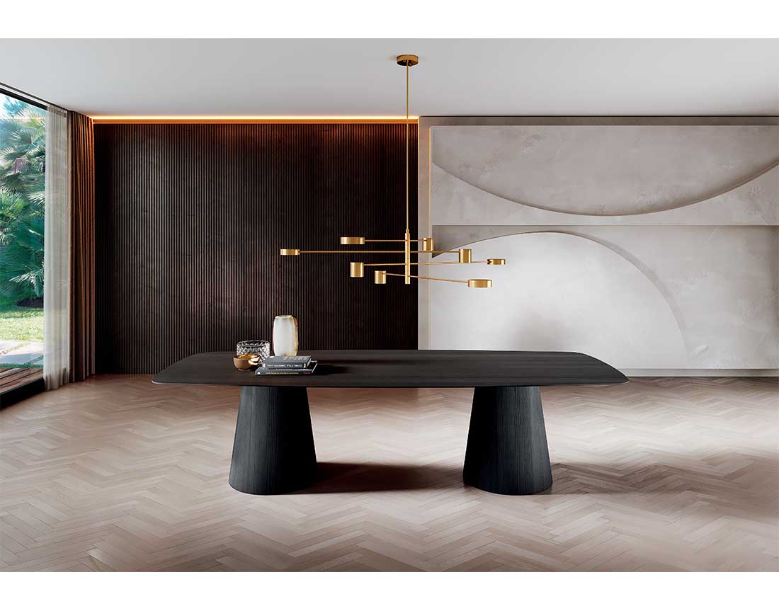 Shell: tavolo due basi in legno con piano legno a botte tinto nero in ambiente moderno | Shell: table with two wooden bases with black-stained barrel wood top in a modern setting